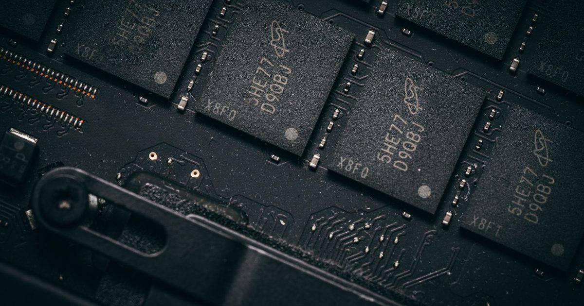 Detailed shot of microchips on a circuit board, showcasing electronic technology and precision engineering.