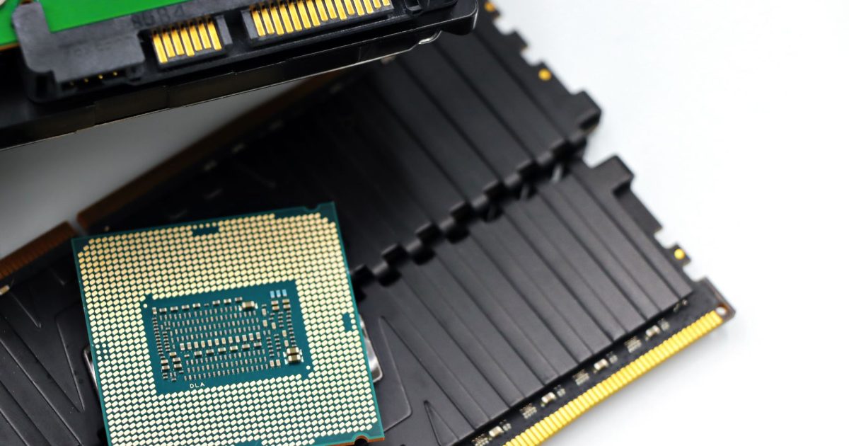 Detailed view of a CPU chip and RAM modules, illustrating computer hardware components.