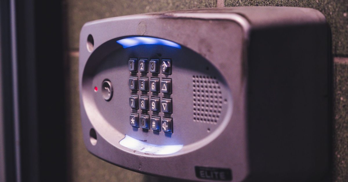 A close-up image of an illuminated security keypad mounted on a wall.
