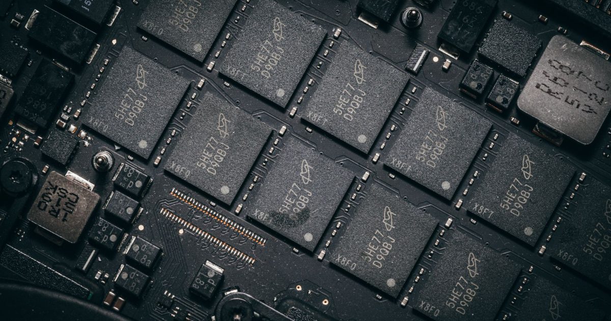 Detailed view of electronic circuit board components showcasing microchips and technology intricacies.