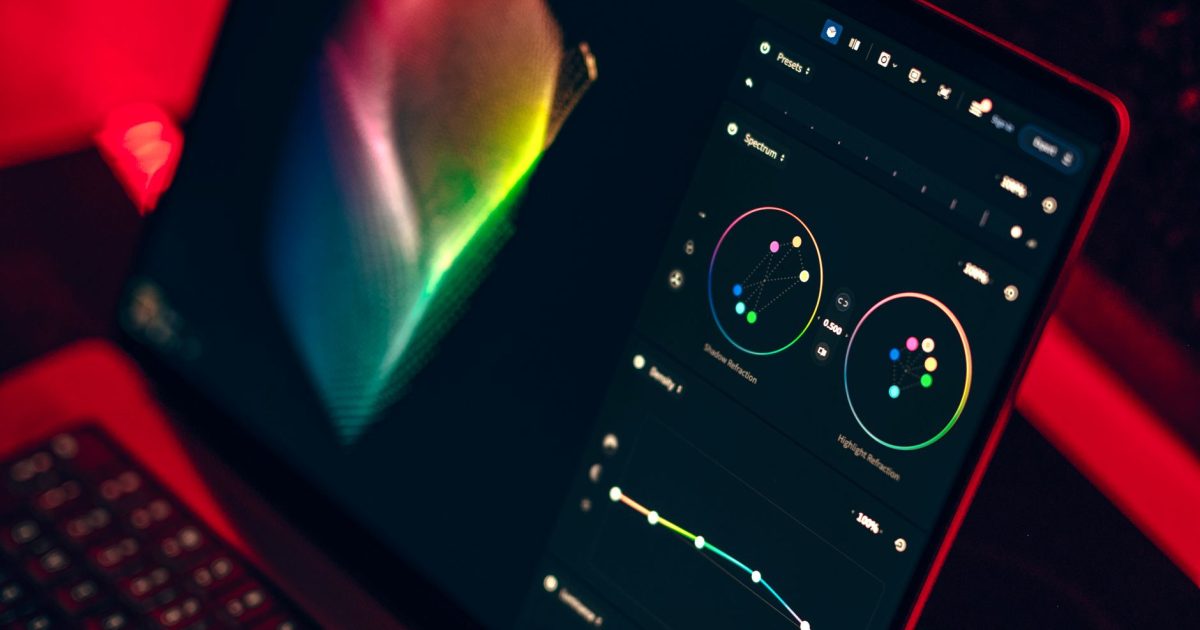 A close-up shot of a laptop displaying a color grading dashboard with vibrant colors.