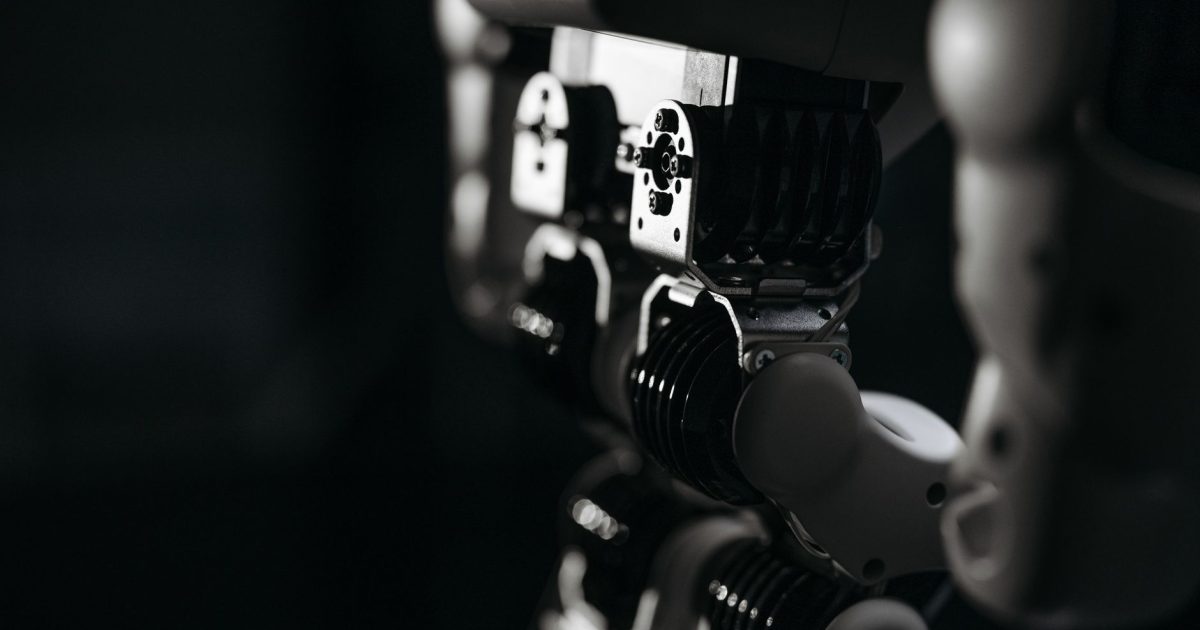 Detailed close-up of a robot's mechanical components, emphasized by moody studio lighting.