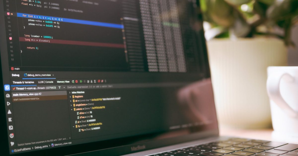 A laptop screen showing programming code and debugging tools, ideal for tech topics.