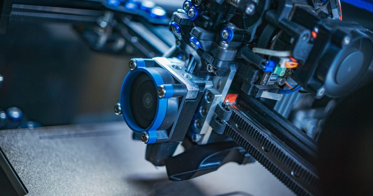 Detailed view of a high-tech 3D printer mechanism showcasing precision engineering.