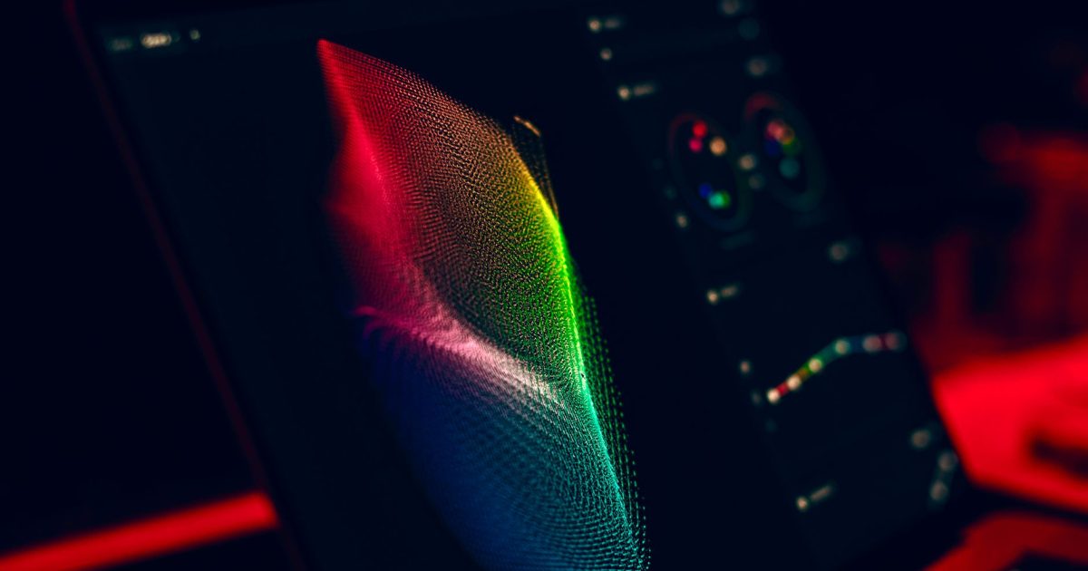 Close-up of vibrant digital art in red, green, and blue displayed on a monitor screen.