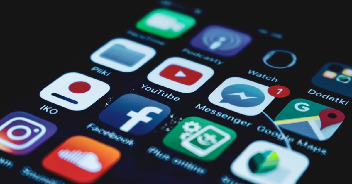 Detailed close-up view of a smartphone screen displaying various popular social media app icons.