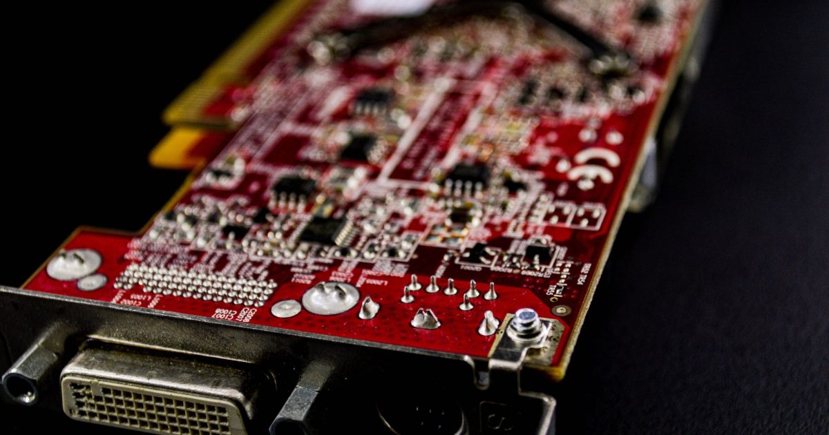 Detailed close-up of a red circuit board showcasing electronic components.