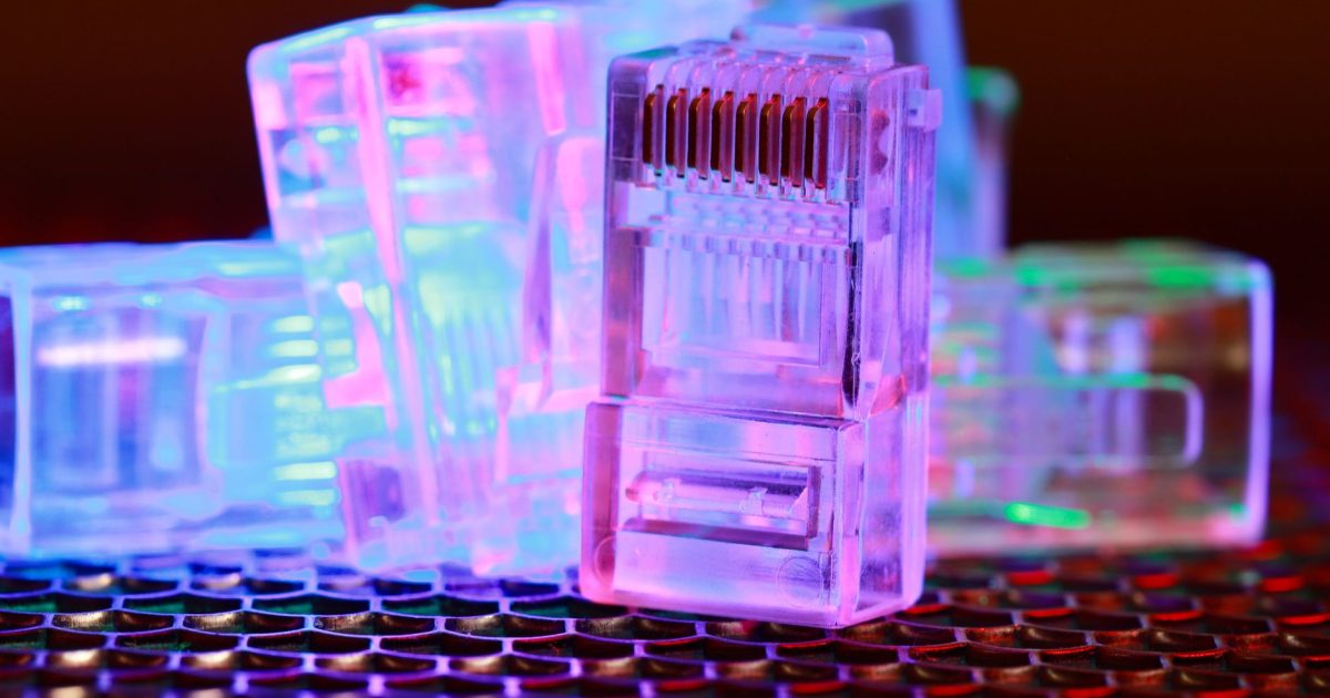 Vibrant close-up of network cable connectors with colorful lighting.