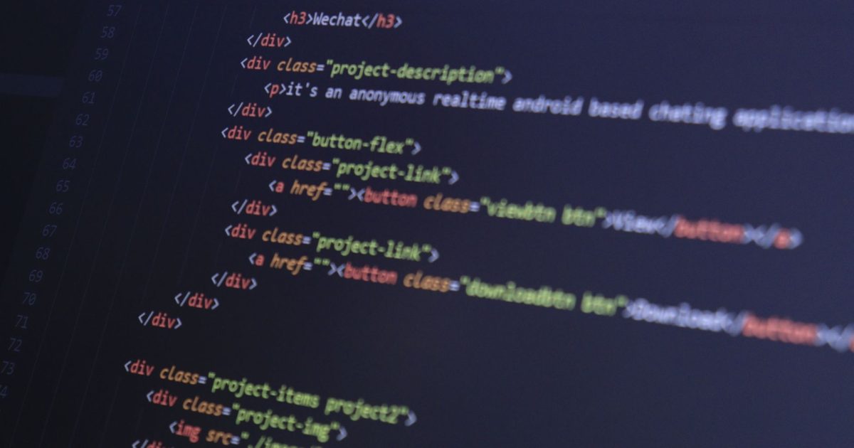 Close-up of HTML code with syntax highlighting on a computer monitor.