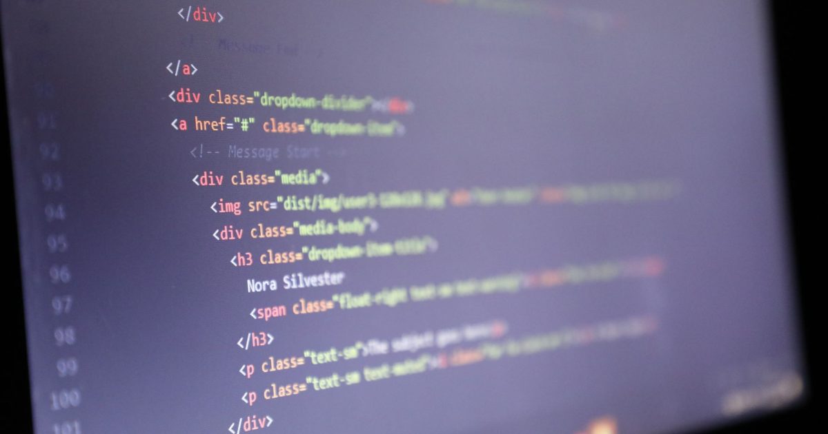 Illuminated HTML code displayed on a computer screen, close-up view.