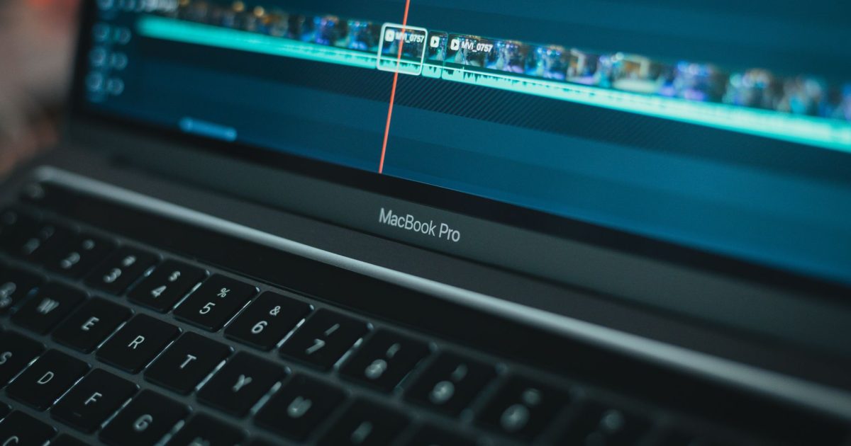 MacBook Pro with video editing software highlighting a timeline, showcasing technology in action.